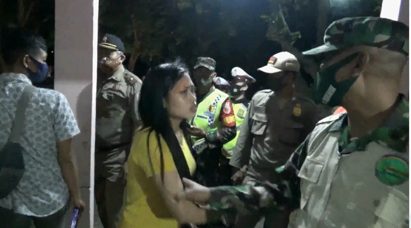 Wanita ini mengamuk sesaat hendak ditindak petugas lantaran melenggar protokol kesehatan (Foto / Metro TV)