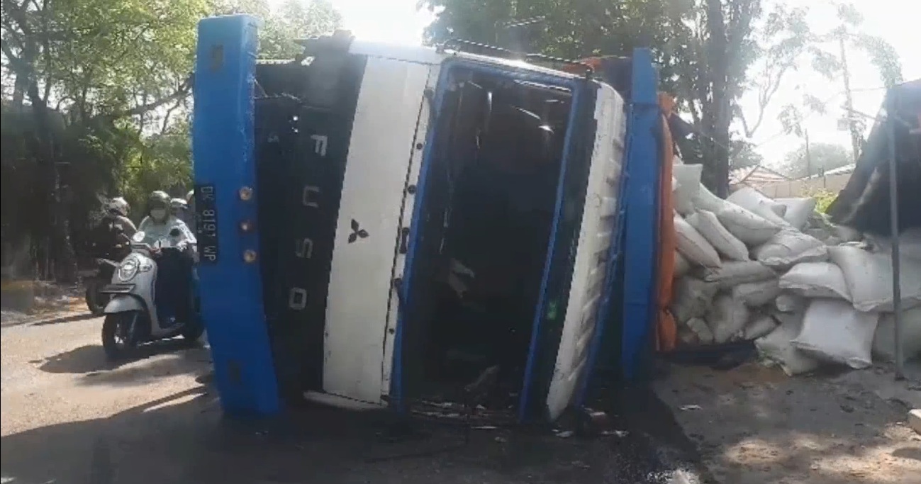 Jalan Ambles, Truk Kelebihan Muatan Tepung Ikan Terguling Timpa Warung