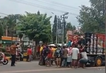 Puluhan massa mengotong jenazah pasien covid-19  ke atas truk. (metrotv)