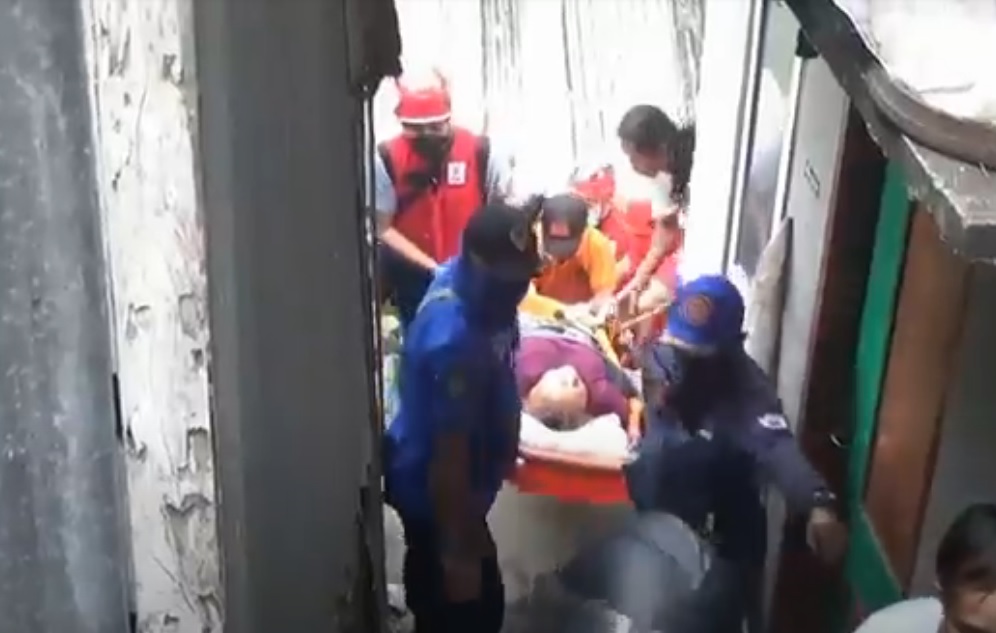 Petugas  harus melawati gang-gang sempit untuk membawa korban ke mobil ambulans. (metrotv)