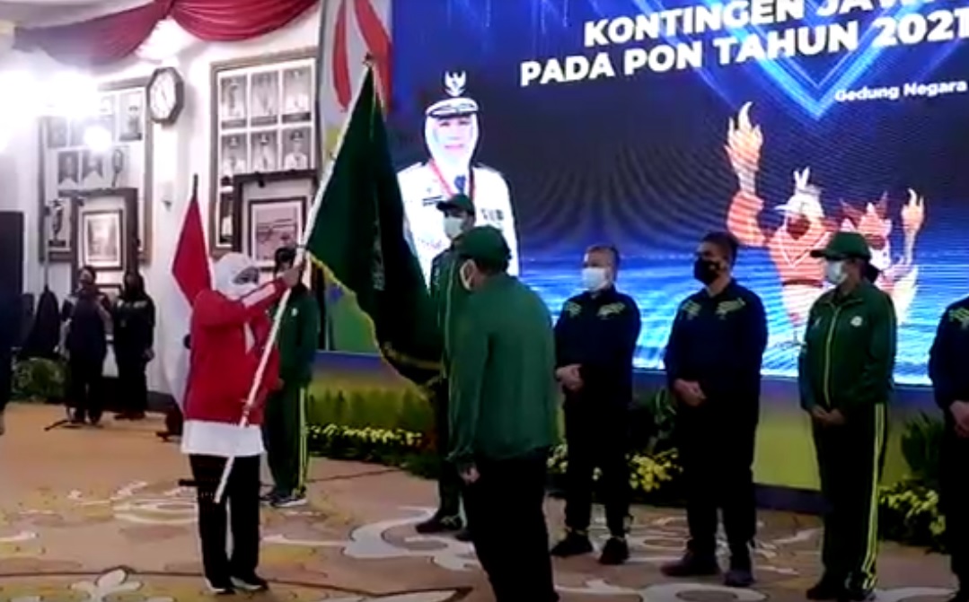 Gubernur Jawa Timur Khofifah Indar Parawansa menyerahkan bendera pataka kepada Ketua KONI Jawa Timur Erlangga Satriagung. (metrotv)