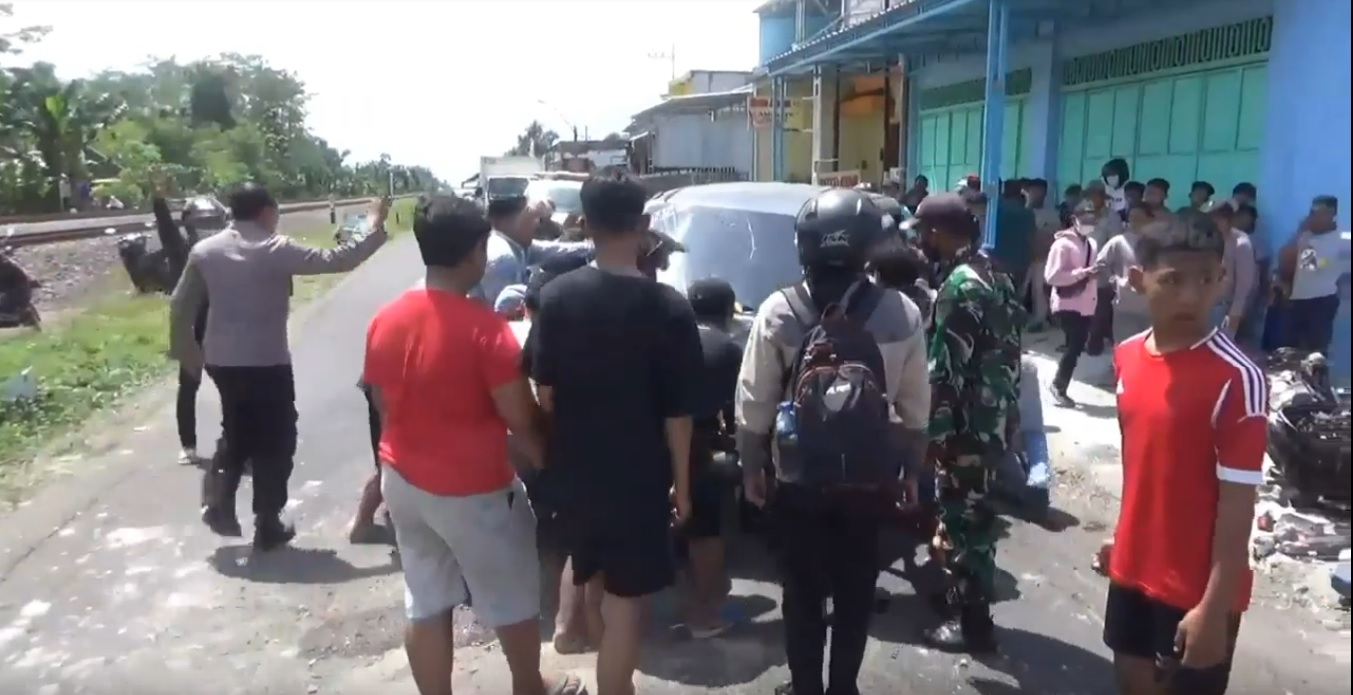 Warga mengevakuasi mobil polisi usai menabrak dua pemotor di Jombang (Foto / Metro TV)