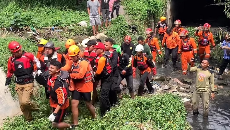 Petugas mengevakuasi RS yang tenggelam usai terseret arus deras sungai (Foto / Istimewa)