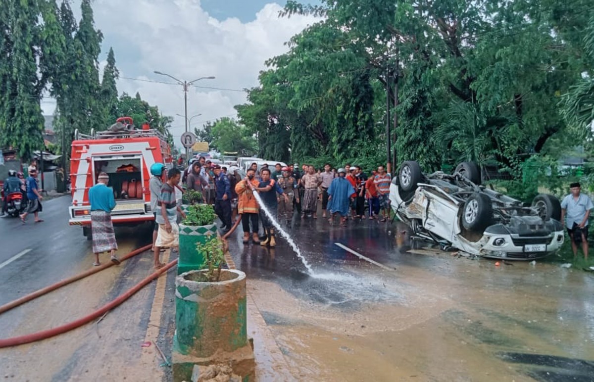 Petugas membersihkan pecahan kaca mobil Pajero di jalanan (Foto / Istimewa)