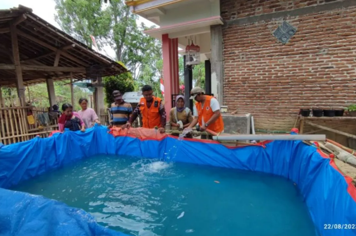 Petugas menggelontor air bersih di sebuah kolam penampungan sementara untuk warga di Ngrencak, Trenggalek, Rabu (23/8/2023), (ANTARA/HO - BPBD Trenggalek)